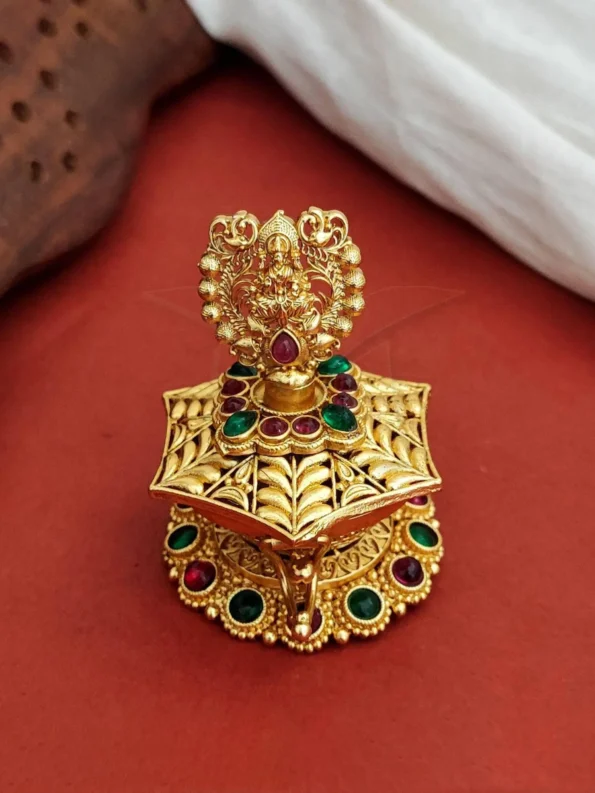 gold Laxmi sindoor box with statue and red green stones